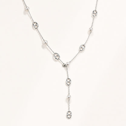 Elegant silver-tone lariat necklace featuring mother-of-pearl and anchor links on a white background.