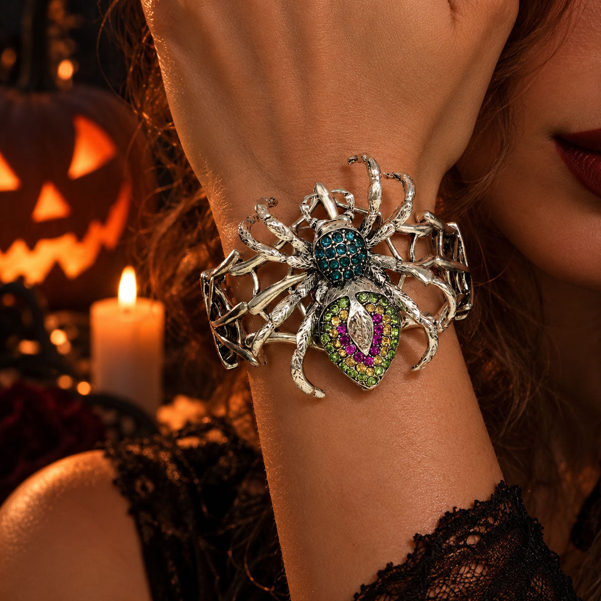 Model wrist featuring silver spiderweb stretch bangle with colorful rhinestone spider