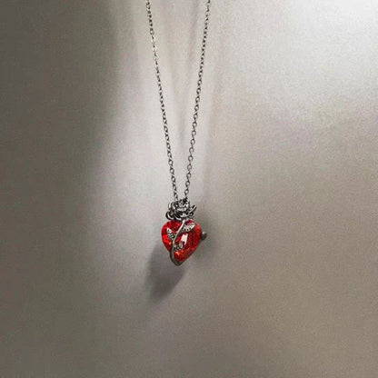 Minimalist studio shot of black alloy rose heart necklace hanging gracefully