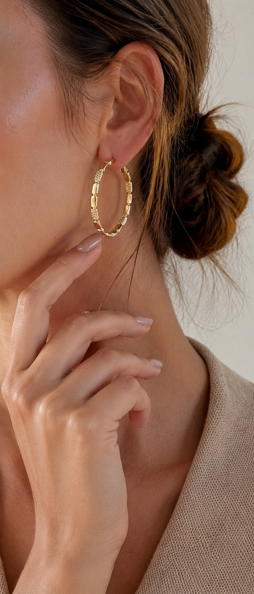 Model with updo hair touching neck showcasing elegant 3.8cm gold and crystal link hoop earrings