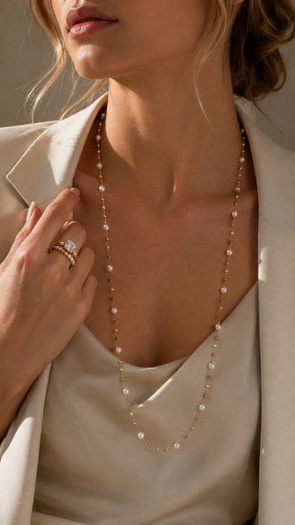 Close-up of model wearing beige blazer layered with 80cm long freshwater pearl opera necklace