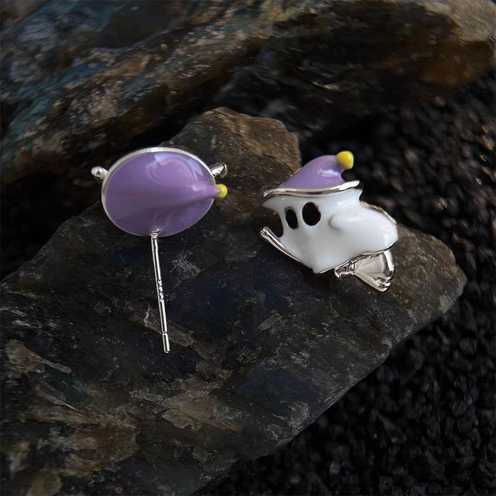 Close-up of flying ghost enamel stud earring showing S925 sterling silver post hallmark on dark stone