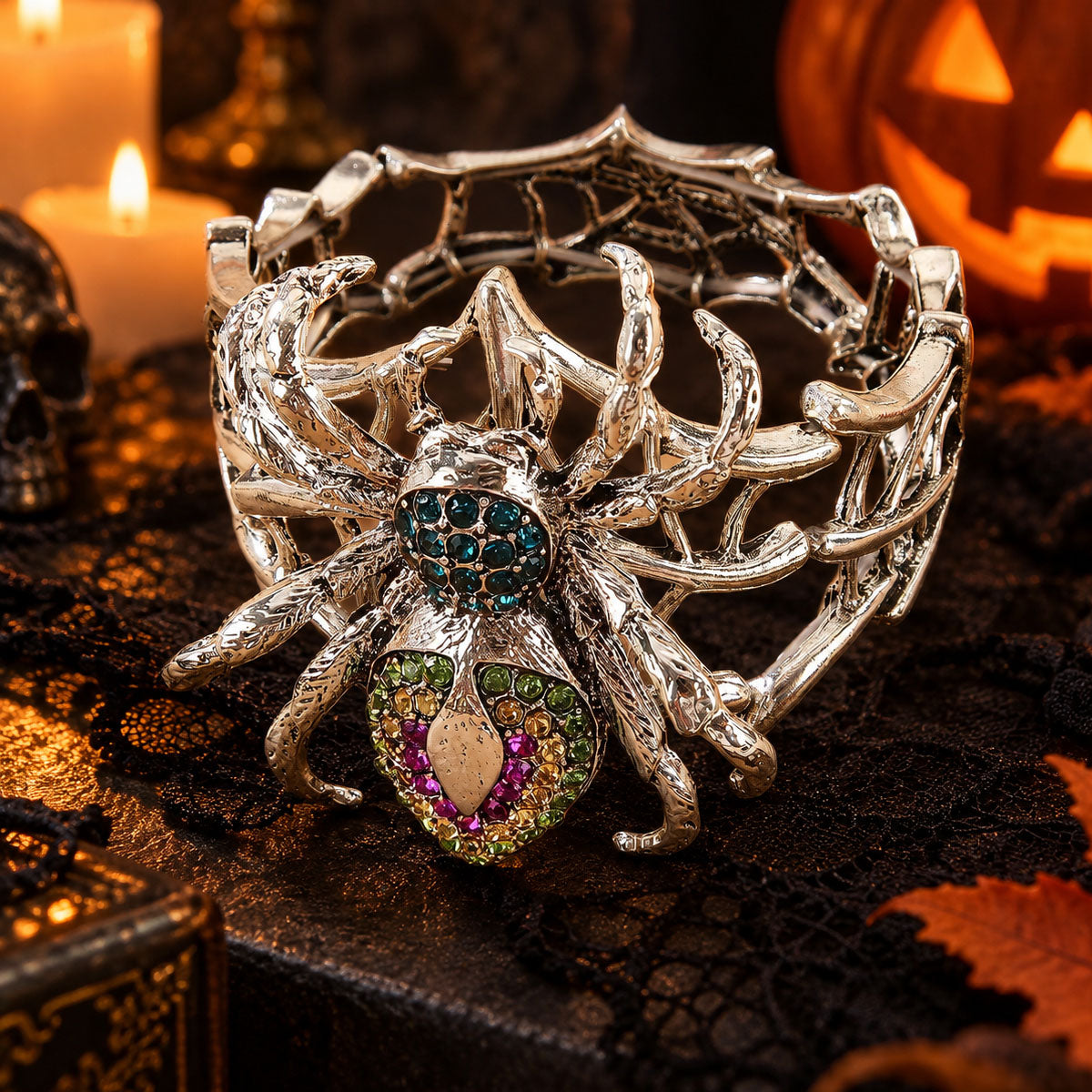 High-angle shot of silver gothic spiderweb cuff bracelet with multi-color rhinestones on dark lace