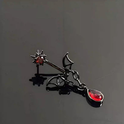 Gothic vampire bat wing ear jacket earring with teardrop drop chain on dark reflective background