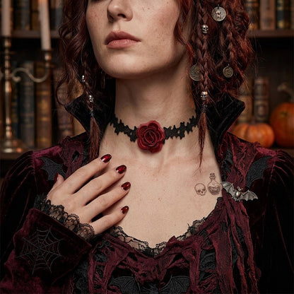 Model wearing vampire-style black lace red rose choker in candlelit Halloween setting