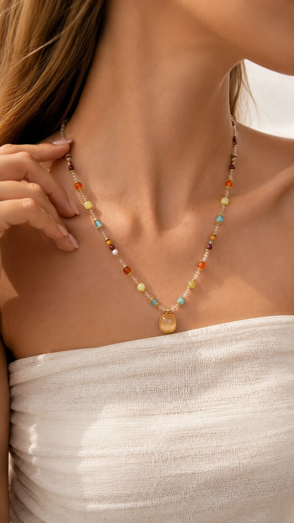 Model wearing a colorful crystal and beaded 18K gold necklace drapes elegantly along the collarbone.